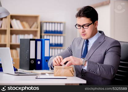 Businessman receiving parcel in office