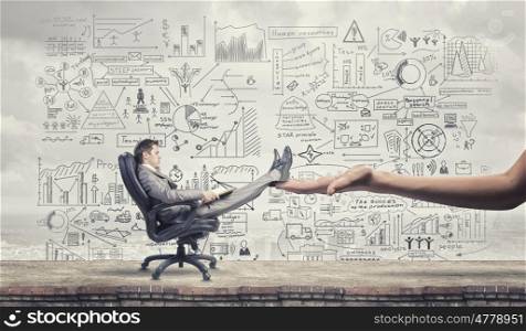 Businessman relaxed in chair. Young handsome businessman sitting in chair with his legs supported by hand