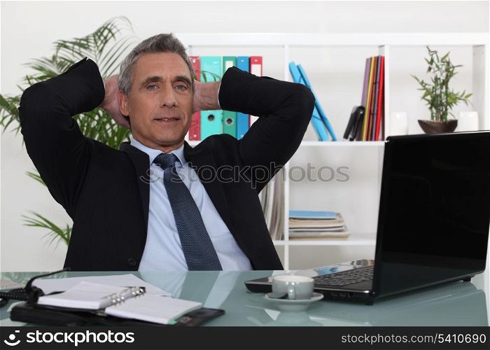 Businessman relaxing at desk