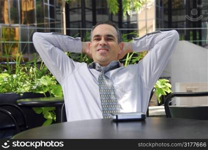 Businessman relaxing in outdoor cafe after work