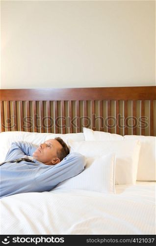 Businessman Relaxing on Bed