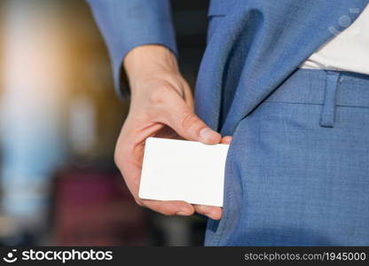 businessman removing blank white card from his pocket. High resolution photo. businessman removing blank white card from his pocket. High quality photo