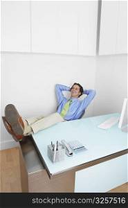 Businessman resting his feet on the desk