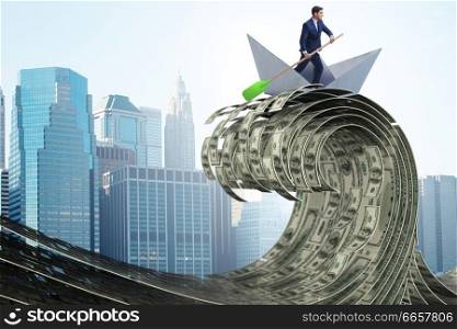 Businessman riding paper boat in dollar sea