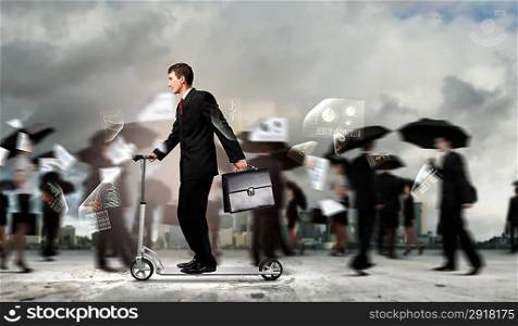 Businessman riding scooter