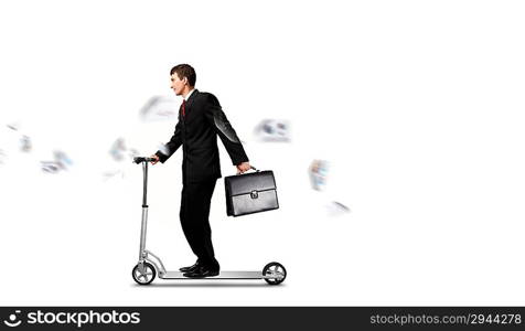 Businessman riding scooter