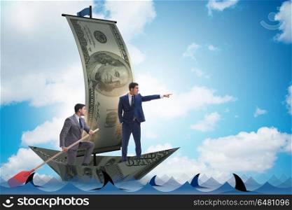 Businessman rowing on dollar boat in business financial concept