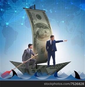 Businessman rowing on dollar boat in business financial concept. The businessman rowing on dollar boat in business financial conc