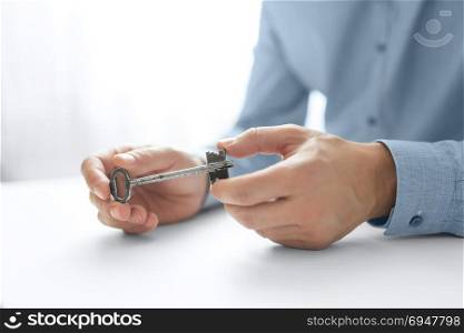 Businessman&rsquo;s hand holding key. Key Business Solutions. Business concept of success.. Businessman&rsquo;s hand holding key. Key Business Solutions. Business concept of success