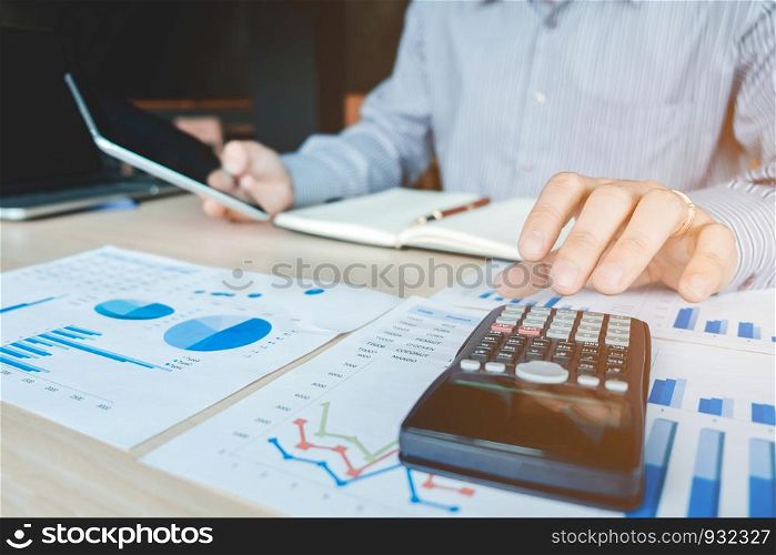 Businessman's hands with calculator at the office and Financial data analyzing counting