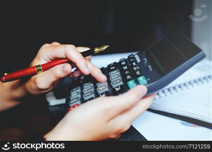 Businessman&rsquo;s hands with calculator at the office and Financial data Cost Economic