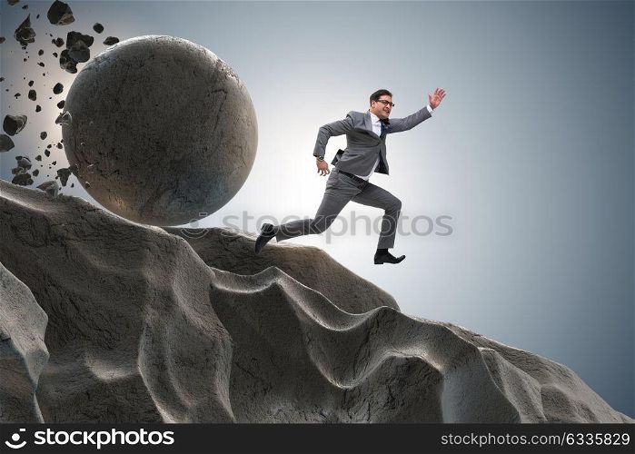 Businessman running away from falling rolling stone