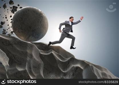 Businessman running away from falling rolling stone