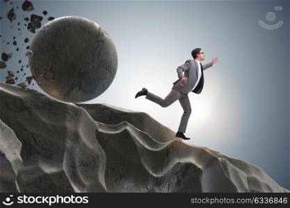 Businessman running away from falling rolling stone. The businessman running away from falling rolling stone