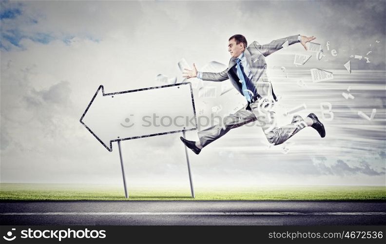 Businessman running on the road. Young businessman in suit running on the road
