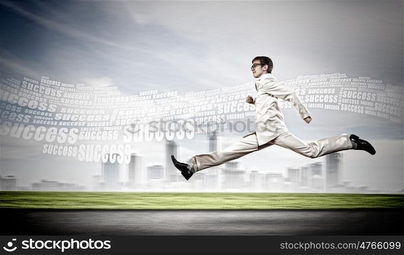 Businessman running on the road. Young businessman in suit running on the road
