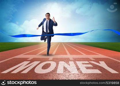 Businessman running towards money on track
