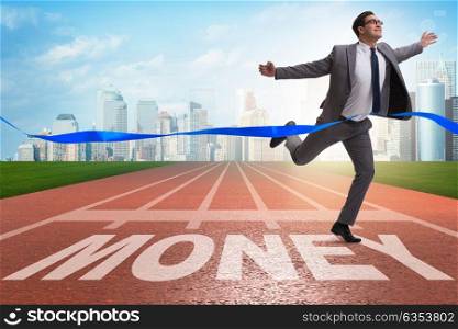 Businessman running towards money on track