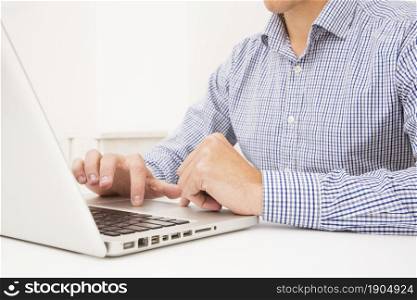 businessman s hand browsing laptop white table. Beautiful photo. businessman s hand browsing laptop white table