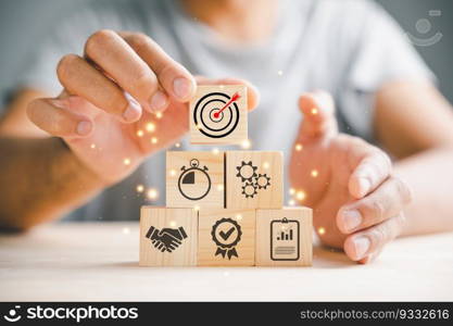 Businessman’s hand carefully stacking wood blocks, signifying the significance of business strategy and Action plan. Copy space provided for professional use.