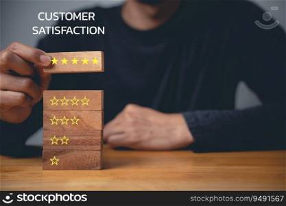 Businessman’s hand selecting wooden block with 5 star icon to show excellent customer satisfaction and positive feedback for services rendered