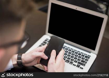businessman s hand using mobile phone front laptop