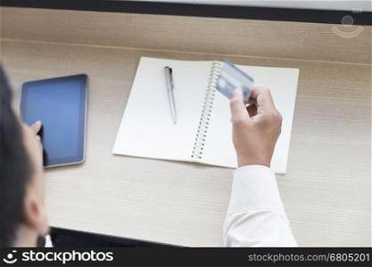 businessman's hand with digital tablet and credit card for payment, shopping online concept