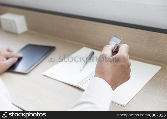 businessman's hand with digital tablet and credit card for payment, shopping online concept