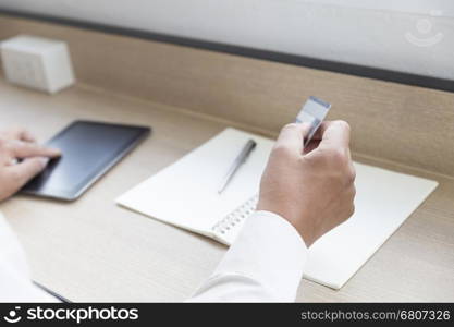 businessman's hand with digital tablet and credit card for payment, shopping online concept