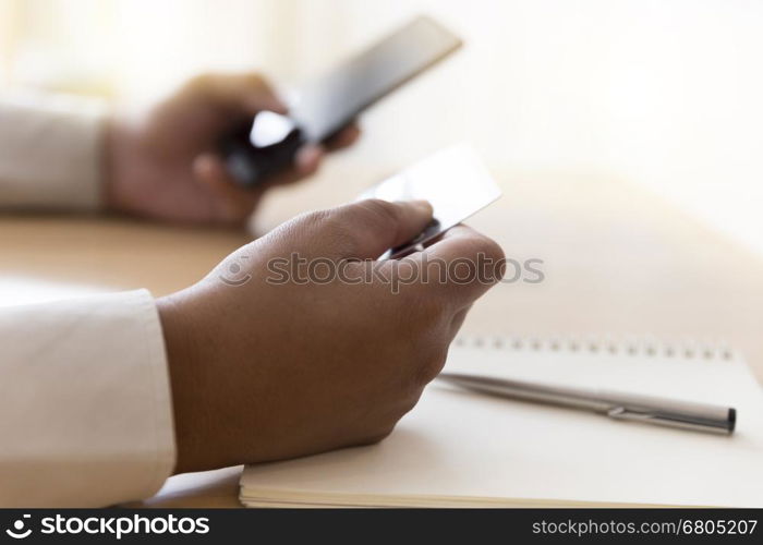 businessman's hand with mobile phone and credit card for payment, shopping online concept