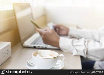 businessman's hand with mobile phone, laptop computer and credit card for shopping online concept