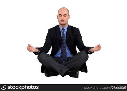 Businessman sat in yoga position
