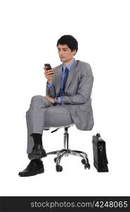 Businessman sat next to briefcase