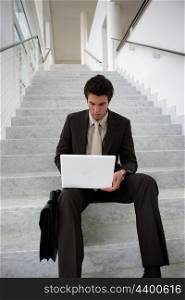 Businessman sat on the stairs