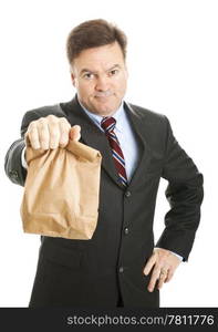 Businessman saving money by bringing his lunch to work in a brown bag. He doesn&rsquo;t look happy. Isolated.