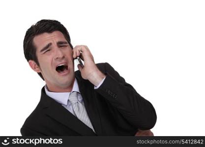 Businessman screaming down the phone