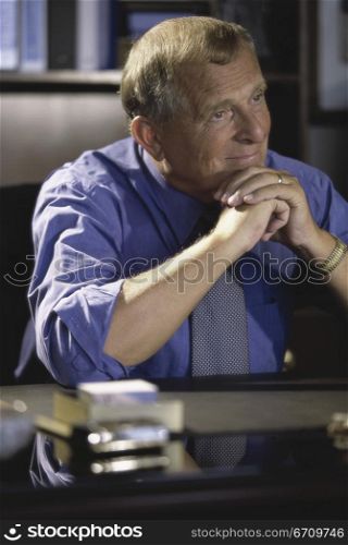 Businessman seated behind an office desk