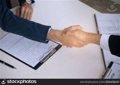 Businessman shaking hands successful candidate at interview. got the job in the team. Welcome aboard.