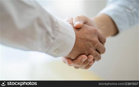 Businessman shaking hands successful making a deal. mans handshake. Business partnership Real estate meeting home purchase agreementconcept