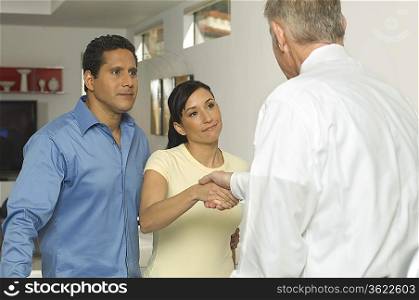 Businessman Shaking Hands with Couple