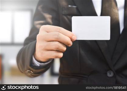 Businessman showing a blank piece of paper. Any business cards design ideas.