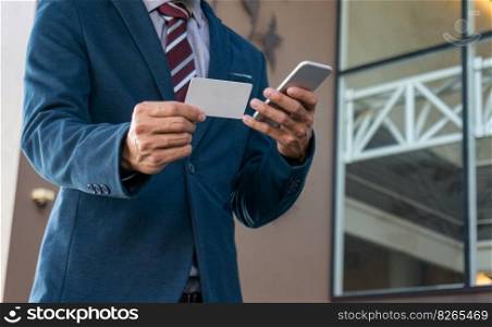 Businessman showing blank business card and holding smart phone.Business man holding white blank card space for text. product display