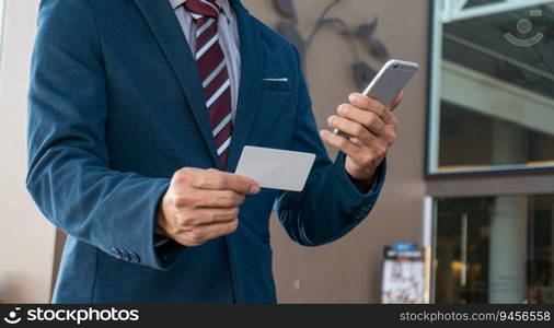 Businessman showing blank business card and holding smart phone.Business man holding white blank card space for text. product display