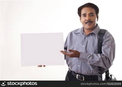 Businessman showing blank sign on white background