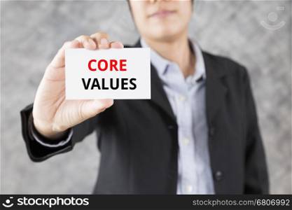 businessman showing business card with word core values