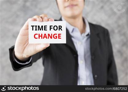 businessman showing business card with word time for change