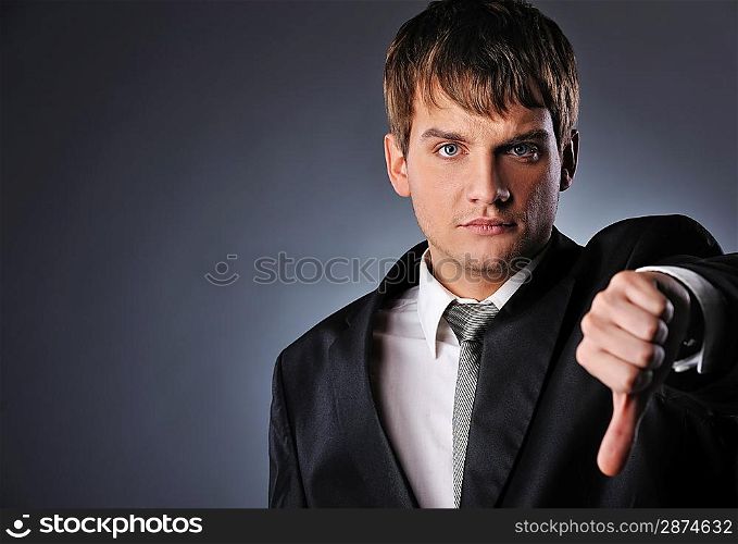 Businessman showing his thumb down