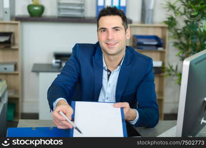 businessman showing partner where to sign agreement