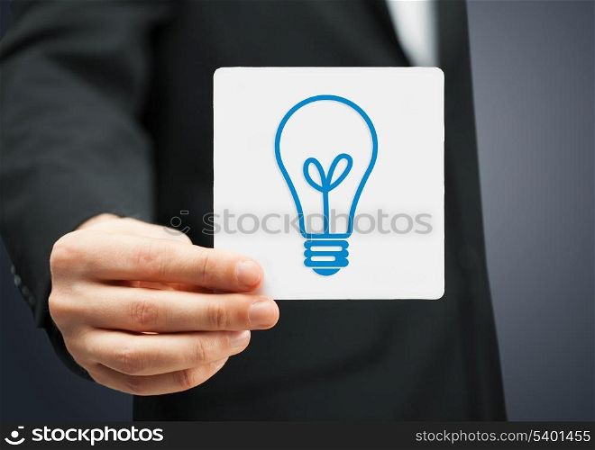 businessman showing sheet with sign of light bulb