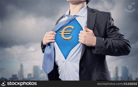 Businessman showing superman suit underneath shirt. Image of young businessman in superhero suit with euro sign on chest